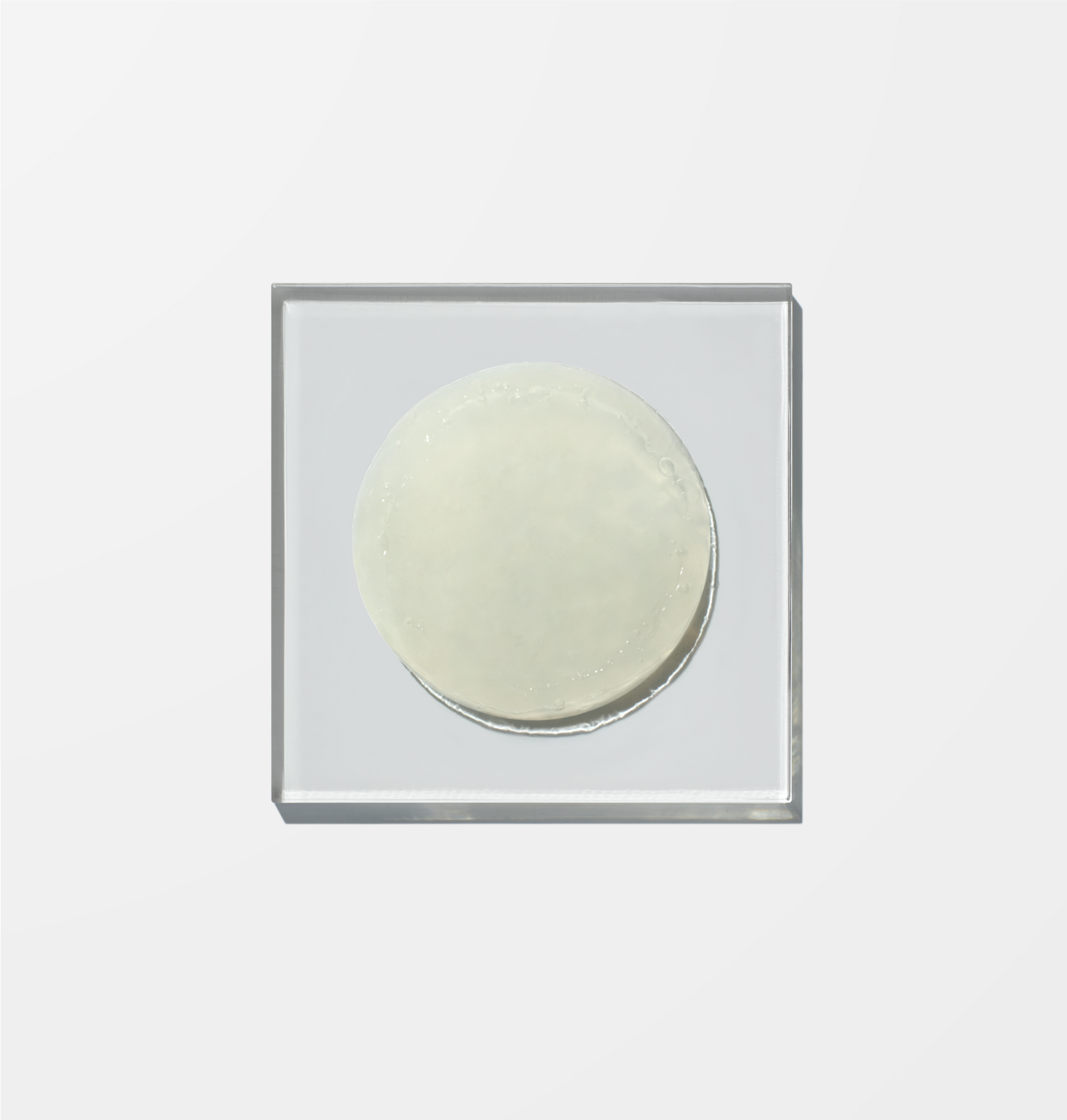 Pale yellow and slightly transparent Ingredients Wellness Face Cleanser on a glass plate